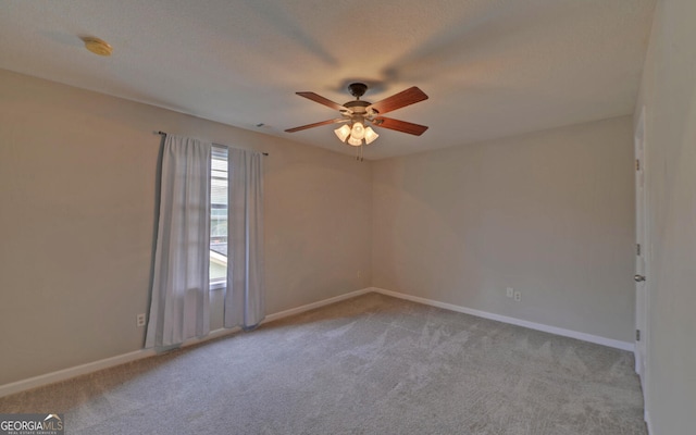 unfurnished room featuring ceiling fan and light colored carpet