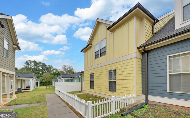 view of side of home featuring central AC unit