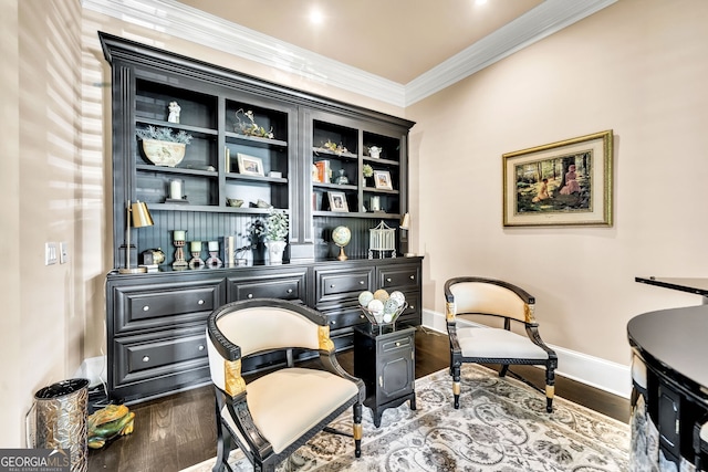 sitting room with hardwood / wood-style floors and crown molding