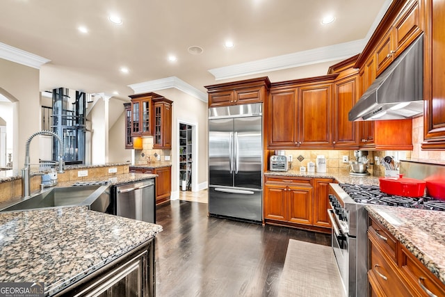 kitchen with ventilation hood, ornamental molding, dark hardwood / wood-style flooring, sink, and high quality appliances