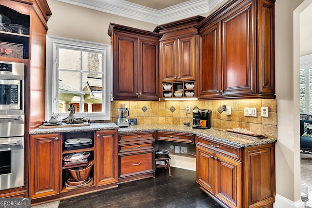 kitchen with stainless steel oven, light stone countertops, a wealth of natural light, and built in desk