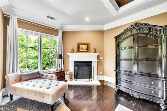 living area featuring dark wood-type flooring and crown molding