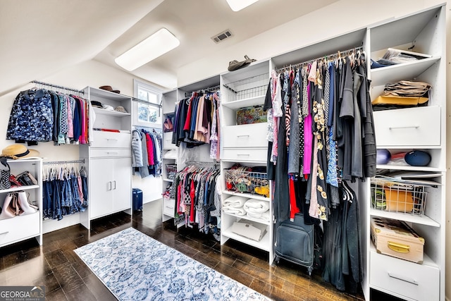 spacious closet featuring dark hardwood / wood-style flooring