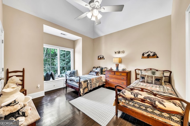 bedroom featuring dark wood-type flooring, lofted ceiling, and ceiling fan