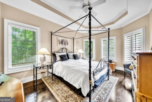 bedroom with ceiling fan, multiple windows, dark hardwood / wood-style flooring, and crown molding