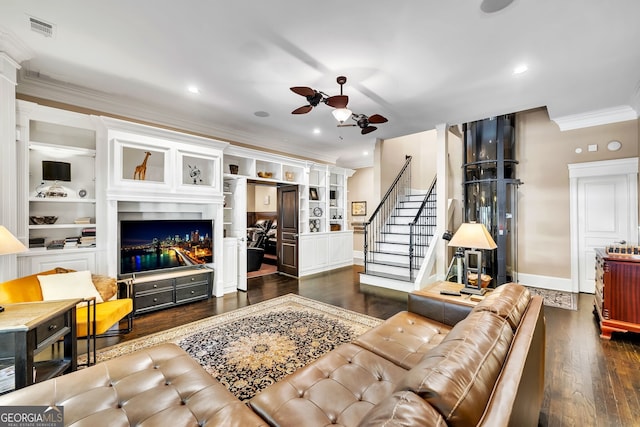 living room featuring ceiling fan, dark hardwood / wood-style floors, built in features, and ornamental molding