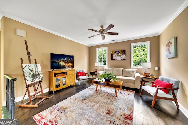 living room with dark hardwood / wood-style flooring, ceiling fan, and crown molding