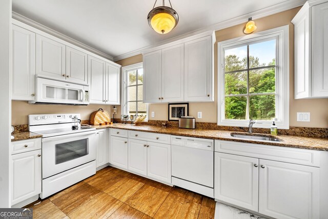 kitchen featuring white cabinetry, white appliances, sink, and a healthy amount of sunlight