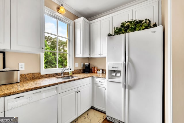 kitchen featuring white appliances, white cabinetry, and a healthy amount of sunlight