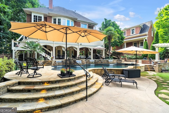 view of swimming pool featuring a jacuzzi, pool water feature, and a patio area