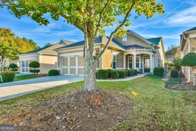 view of front of house with a front yard and a garage