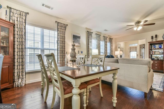 dining room with dark hardwood / wood-style floors, ceiling fan, and a healthy amount of sunlight