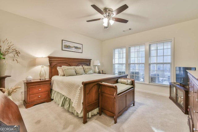 bedroom with ceiling fan and light carpet