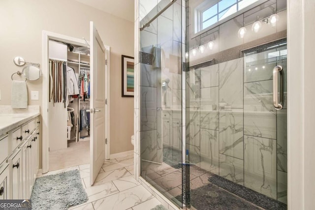 bathroom with vanity, a shower with shower door, and toilet