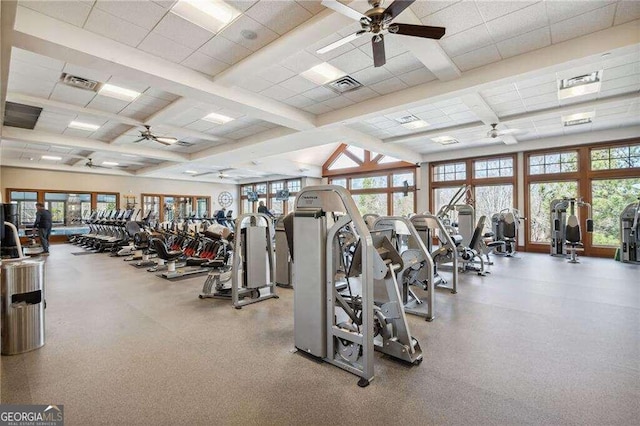 gym featuring ceiling fan and a paneled ceiling