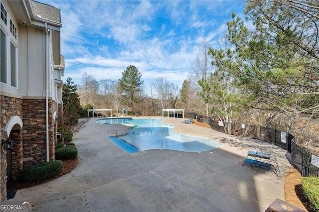 view of pool with a patio and a pergola