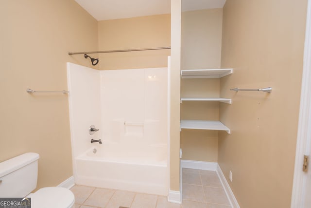 bathroom featuring tile patterned flooring, shower / tub combination, and toilet