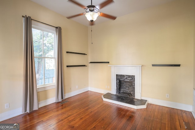 unfurnished living room featuring wood-type flooring and ceiling fan