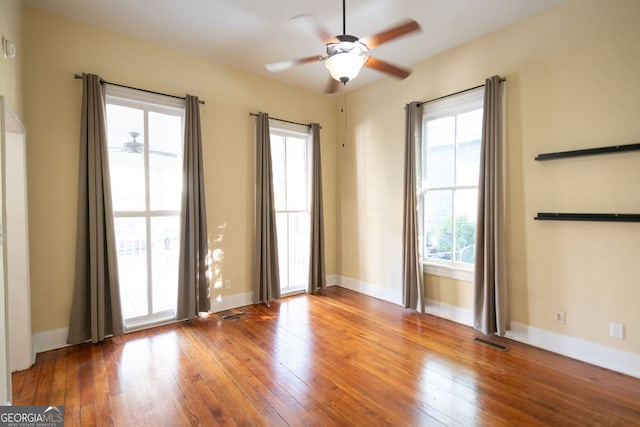 spare room featuring ceiling fan and a healthy amount of sunlight