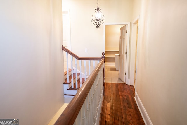 corridor featuring a chandelier and hardwood / wood-style flooring