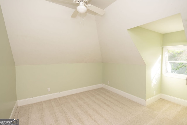 additional living space featuring light carpet, ceiling fan, and vaulted ceiling