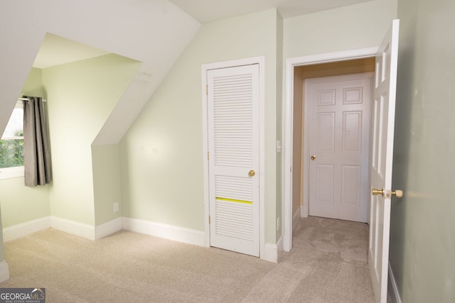 additional living space featuring light carpet and lofted ceiling