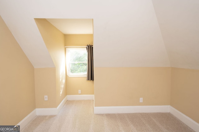 bonus room featuring lofted ceiling and light carpet