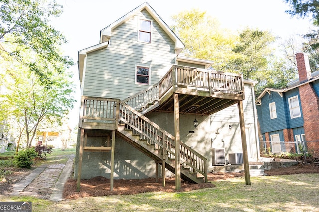 rear view of house featuring central AC unit and a deck