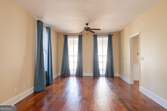 unfurnished room featuring ceiling fan and dark hardwood / wood-style floors