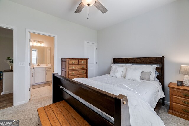 carpeted bedroom with sink, ceiling fan, and ensuite bathroom