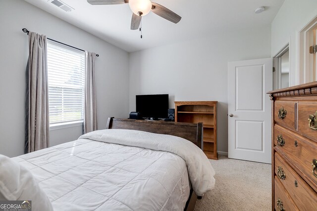 bedroom featuring ceiling fan and light colored carpet