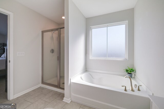 bathroom with tile patterned flooring and plus walk in shower