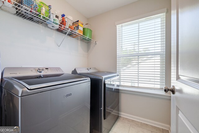 washroom featuring separate washer and dryer and light tile patterned floors