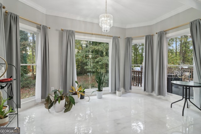 dining area featuring a notable chandelier, a wealth of natural light, and crown molding