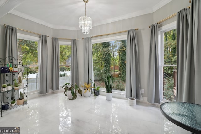 unfurnished dining area featuring a healthy amount of sunlight, an inviting chandelier, and ornamental molding