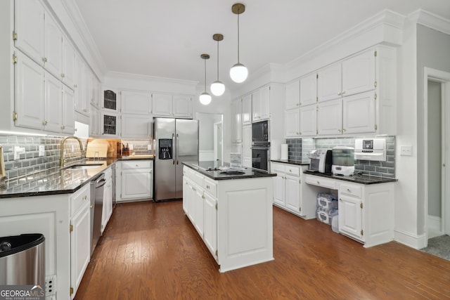 kitchen featuring black appliances, backsplash, a sink, and crown molding