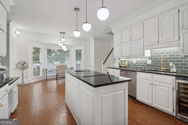 kitchen featuring dishwasher, a kitchen island, decorative light fixtures, and white cabinets