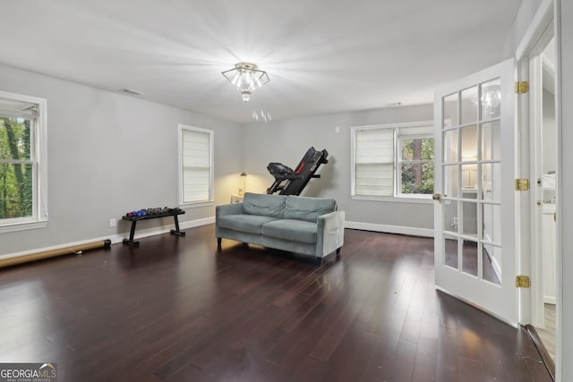 living area with a healthy amount of sunlight and dark hardwood / wood-style floors