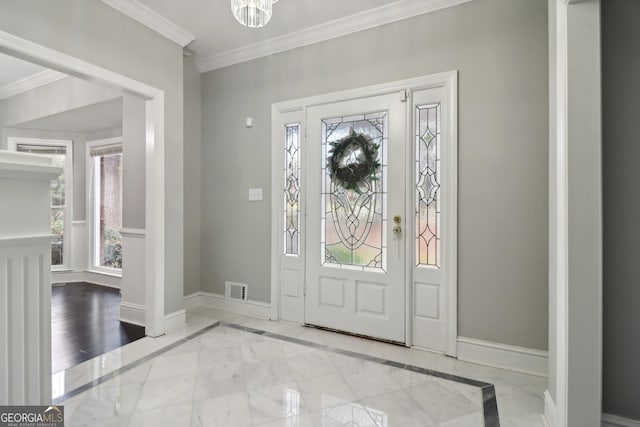 foyer entrance with light hardwood / wood-style flooring, a wealth of natural light, and crown molding