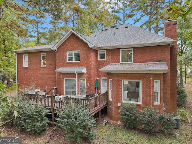 rear view of house with a wooden deck