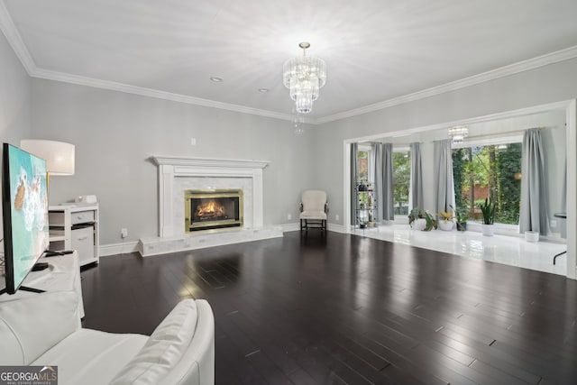 living area with a notable chandelier, a premium fireplace, wood finished floors, baseboards, and ornamental molding