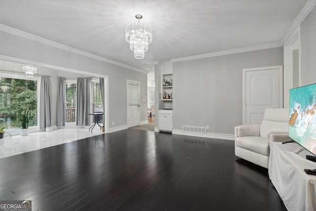 unfurnished living room featuring dark hardwood / wood-style flooring, a chandelier, and ornamental molding