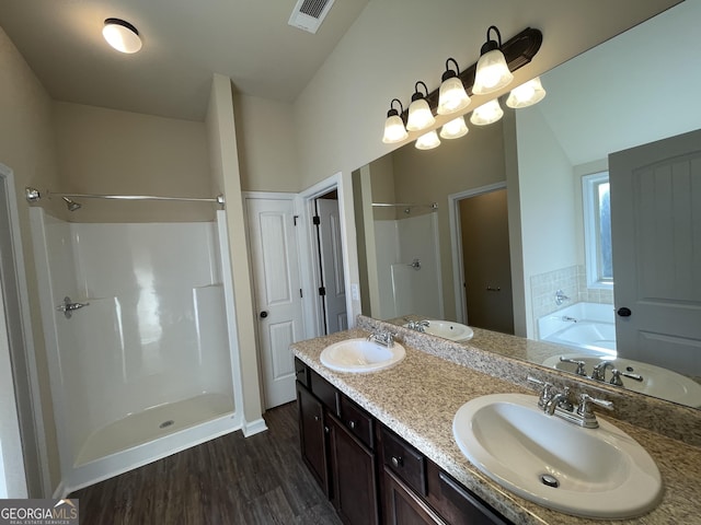 bathroom with plus walk in shower, vanity, and hardwood / wood-style flooring