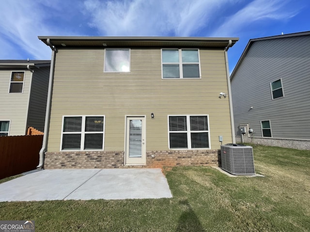 back of house featuring a patio, central AC, and a lawn