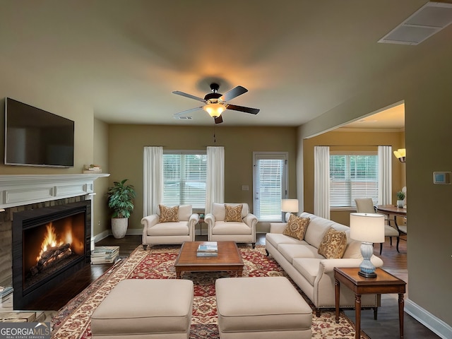 living room featuring ceiling fan and dark wood-type flooring