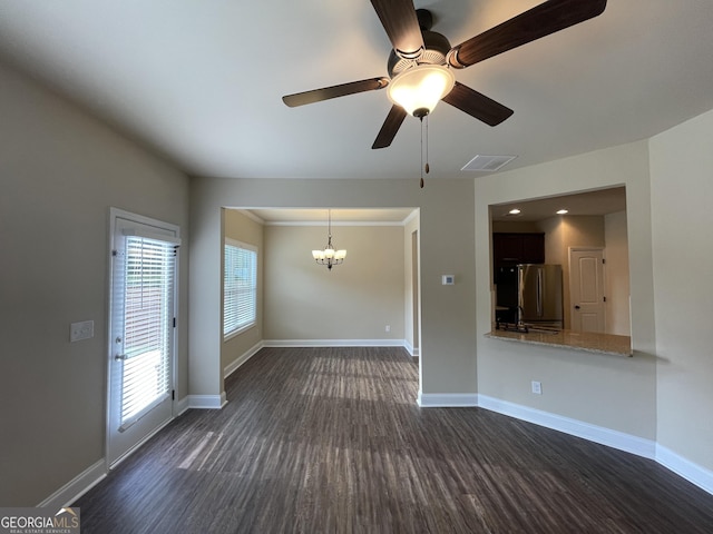 unfurnished living room with ceiling fan with notable chandelier and dark wood-type flooring