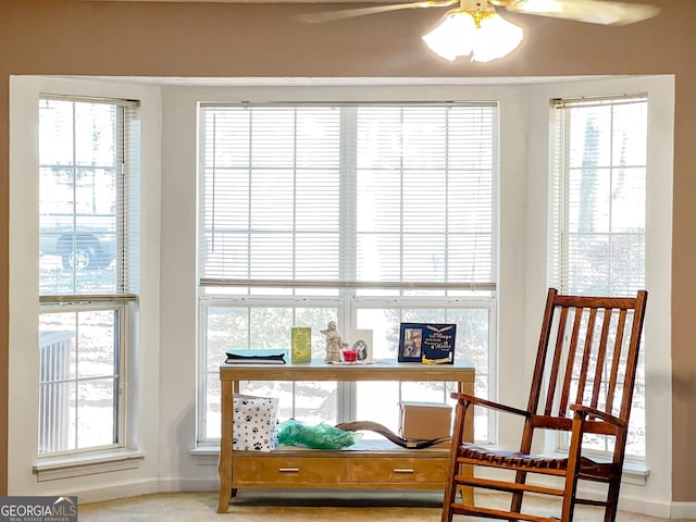 interior space featuring carpet floors, a healthy amount of sunlight, and ceiling fan