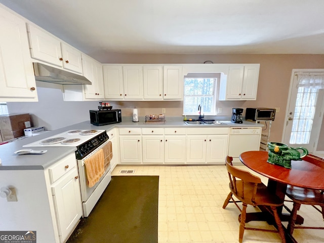 kitchen with white cabinets, sink, and white appliances