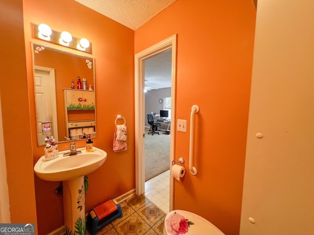 bathroom with sink and a textured ceiling