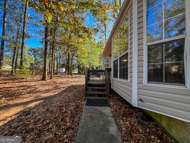 view of home's exterior with a wooden deck